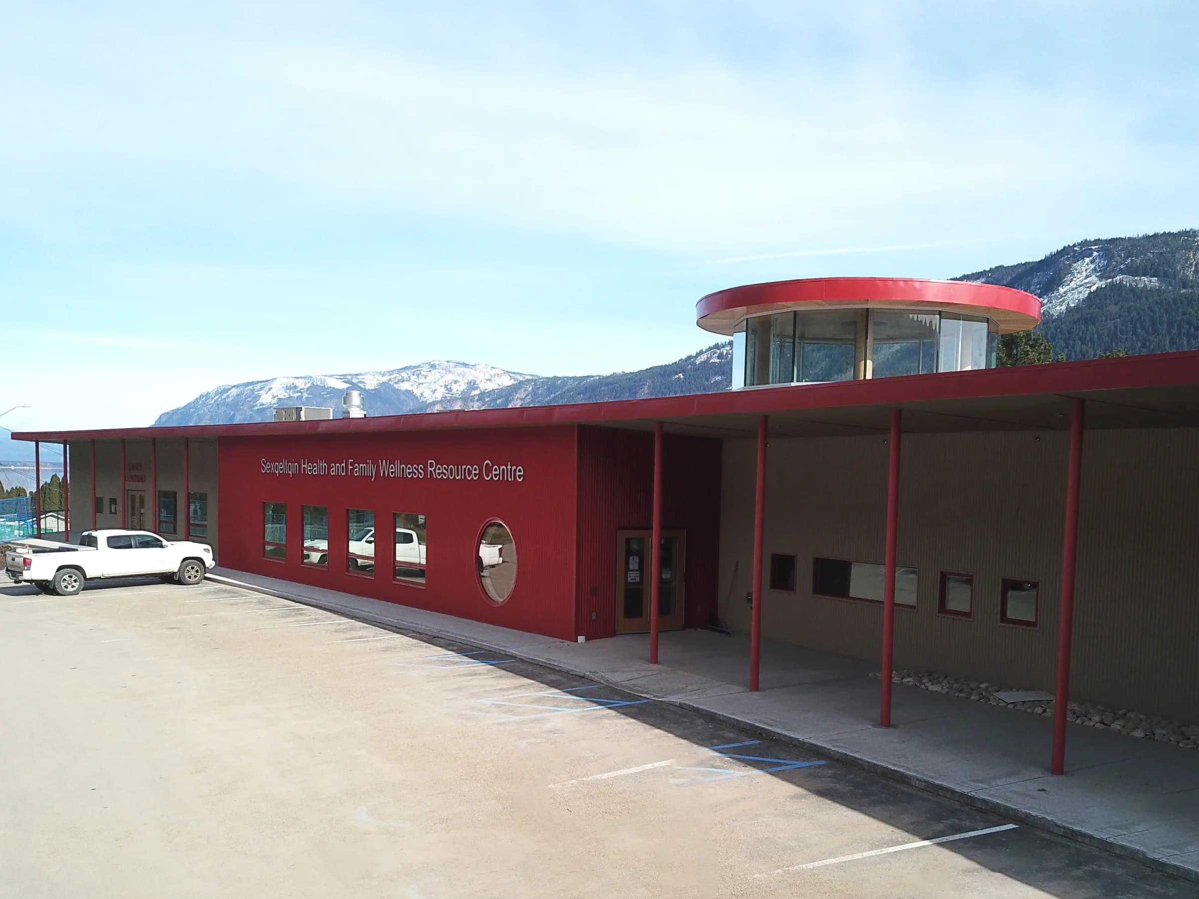 The centre seen from the approach road, snow-capped mountains behind.